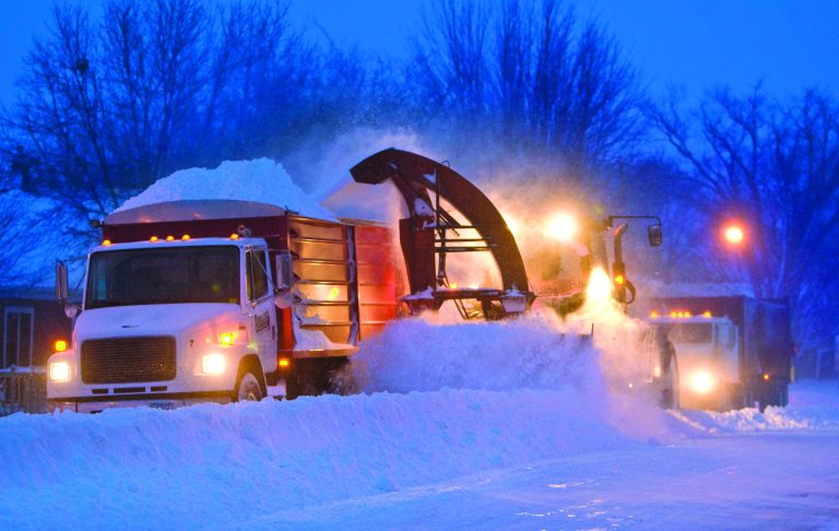 Snow clearing crews in Pine Island, Minn were out early trying to clear roads before morning commuters headed to work on Thursday, Dec. 20, 2012. The first major snowstorm of the season began its slow eastward march across the Midwest early Thursday, creating treacherous driving conditions and threatening to disrupt some of the nation's busiest airports ahead of the holiday weekend. (AP Photo/The Rochester Post-Bulletin, Jerry Olson)