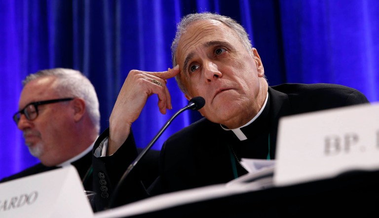Cardinal Daniel DiNardo of the Archdiocese of Galveston-Houston, president of the United States Conference of Catholic Bishops, listens to a reporter's question during a news conference during the USCCB's annual fall meeting, Monday, Nov. 12, 2018, in Baltimore. 