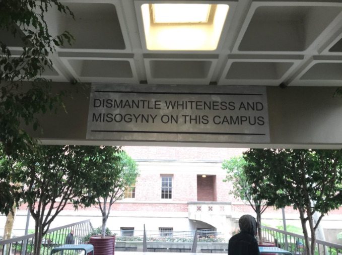 A banner saying "Dismantle Whiteness and Misogyny on This Campus" is displayed in the University of Southern Californiaâs Annenberg Journalism Hall.