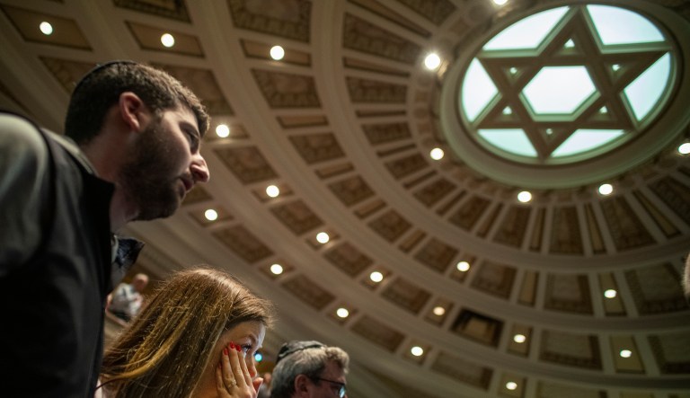 Mark and Allie Divine attend a memorial for those killed and injured in Saturday's deadly shooting at a synagogue in Pittsburgh, as they gather at Temple Israel in Crystal, Minn., Sunday, Oct. 28, 2018.