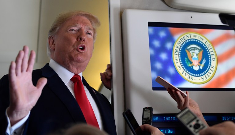 President Donald Trump talks to reporters while in flight from Billings, Mont., to Fargo, N.D., Friday, Sept. 7, 2018.