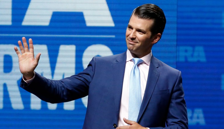 FILE - In this May 4, 2018, file photo, Donald Trump Jr., waves from the stage at the National Rifle Association in Dallas. A dispute between two political families escalated June 19 as Donald Trump Jr. canceled plans to raise money for George P. Bush, the eldest son of former Florida Gov. Jeb Bush. Trump Jr. decided to withdraw from a fundraiser after Jeb Bush criticized the presidentâs immigration policy, according to two people with direct knowledge of the situation who spoke on condition of anonymity.