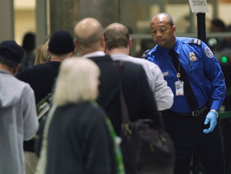 A TSA official checks passengers entering a security checkpoint at Hartsfield-Jackson Atlanta International Airport in November 2010. (AP Photo/David Goldman)