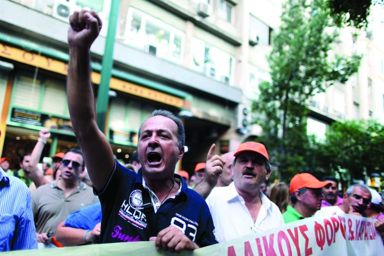 Finance Ministry, tax office and customs employees march in central Athens outside the finance ministry building to protest new austerity measures, on Thursday, Sept. 27, 2012. As the party leaders conferred Thursday, tax and customs employees, who are on strike until Friday against planned pay cuts, held a peaceful protest in the capital. (AP Photo/Petros Giannakouris)