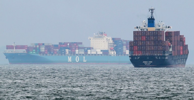 FILE - In this April 21, 2014 file photo, container ship Josco View, of Hong Kong, right, and Panama's container ship Mol Earnest sail through a port in Yokohama, southwest of Tokyo. Japan's trade deficit narrowed in April as exports grew faster than imports following an increase in the sales tax that is expected to dampen demand for some time. The 808.9 billion yen ($8 billion) deficit in April, according to preliminary figures released Wednesday, May 21, 2014 by the Ministry of Finance, compared with a gap of 877.4 billion yen a year earlier and with a 1.7 trillion yen deficit in March. (AP Photo/Koji Sasahara, File)