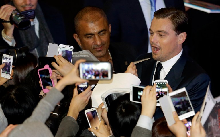 Actor Leonardo DiCaprio signs autographs for fans during the premiere of his new film 