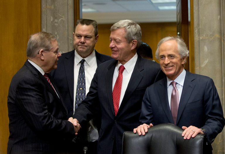Retiring Montana Sen. Max Baucus, center, shakes hands with Senate Foreign Committee Chairman Sen. Bob Menendez, D-NJ., accompanied by the committee's ranking Republican Sen. Bob Corker, R-Tenn., right, and Sen. Jon Tester, D-Mont., on Capitol Hill in Washington, Tuesday, Jan. 28, 2014, prior to the start of the committee's hearing on Baucus nomination to become US ambassador to China. (AP Photo/Pablo Martinez Monsivais)