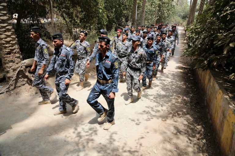 Iraqi police officers and newly recruited policemen march at a police recruiting office in Baghdad, Iraq, July 5, 2014.Â Hundreds of Iraqi soldiers are missing and feared to be dead after a suicide mission in Iraq's western Anbar province.Â (AP Photo/Karim Kadim)