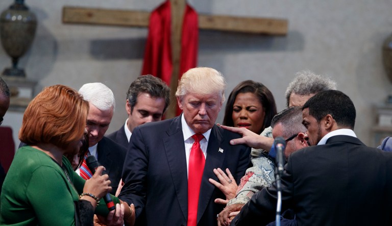 People lay hands on Republican presidential candidate Donald Trump as they pray during a visit to the Pastors Leadership Conference at New Spirit Revival Center, Wednesday, Sept. 21, 2016, in Cleveland, Ohio. Pence said Trump feels a lot of gratitude for evangelical Christians who supported him in last year's presidential election and the president 