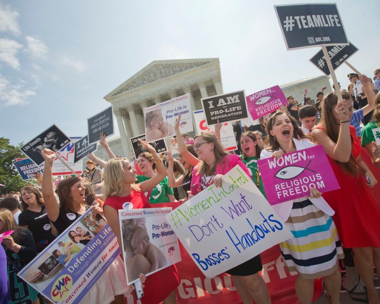 Demonstrator react to hearing the Supreme Court's decision on the Hobby Lobby case outside the Supreme Court in Washington on Monday. (AP Photo/Pablo Martinez Monsivais)