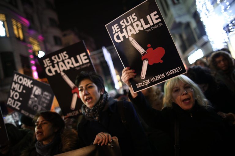 People hold placards that read 