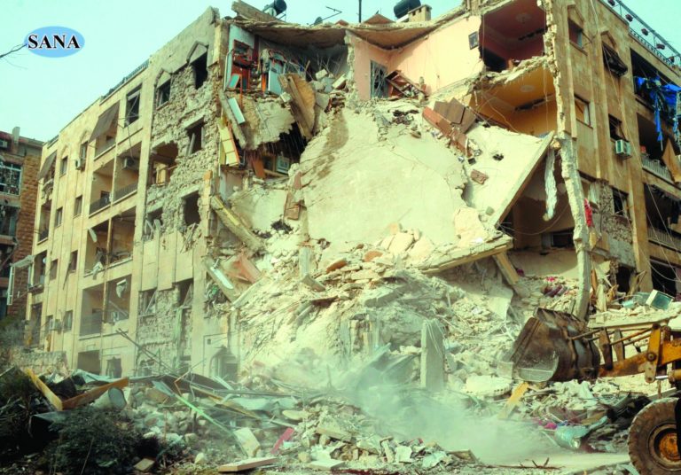 This photo released by the Syrian official news agency SANA, shows damage after a rocket slammed into a building, killing at least 12 people, in Aleppo, Syria, Friday, Jan. 18, 2013. In a spike in civil war violence that Syrian state media blamed on rebel fighters a rocket attack in the northern city of Aleppo occurred during a particularly bloody week nearly two years after an uprising began against Assad's regime. (AP Photo/SANA)