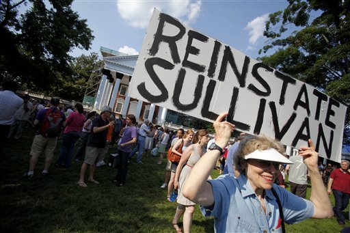 Charlottesville resident Susan Seidler holds aloft a sign in support of ousted University of Virginia President Sullivan at a silent vigil. (AP Photo)