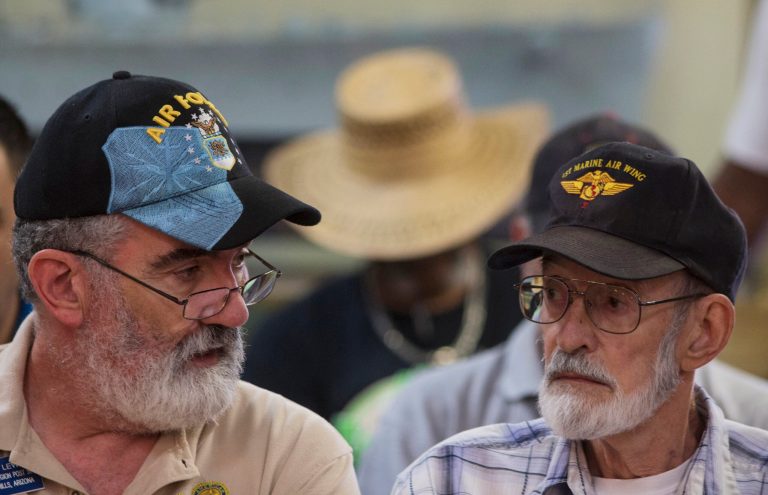 Vietnam veteran Gene Stoesser, right, talks with Veterans Crisis Command Center volunteer Chuck Lewis, left, while he waits for an appointment Tuesday, June 10, 2014, at American Legion Post 1 in Phoenix. Stoesser was told on May 2, 2014, that he needs heart surgery. The American Legion has set up a crisis center in Phoenix to help veterans get medical care in a first-of-its-kind event in the American Legion's nearly 100-year history.(AP Photo/The Arizona Republic, Mark Henle) MESA OUT  MARICOPA COUNTY OUT  MAGS OUT  NO SALES