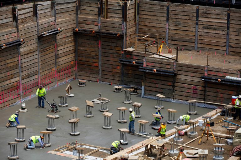   In this Wednesday, June 12, 2013 photo, construction workers lay out a cement foundation at a Brasfield and Gorrie construction site for the Emory Proton Therapy Center, in Atlanta. The government reports on U.S. construction spending in June on Thursday, Aug. 1, 2013. (AP Photo/Jaime Henry-White)  