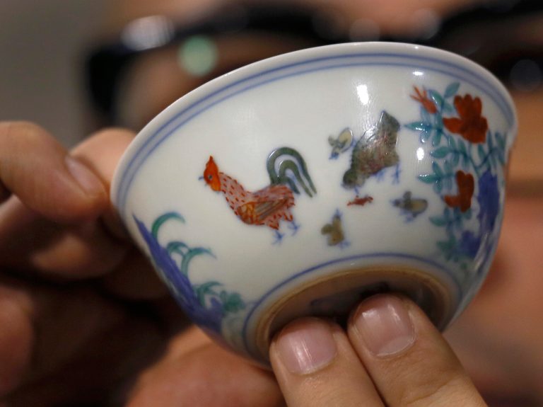 The Meiyintang âChicken Cupâ from the Chinese Ming Dynasty (1368-1644) is displayed during a press conference in Hong Kong, Tuesday, April 8, 2014. Sothebyâs said Shanghai collector Liu Yiqian won the bidding for the âchicken cup,â which is decorated with a rooster, hen and their chicks. Including the auction houseâs commission, the price for the small cup comes to HK$281.2 million (US$36.1 million), which Sothebyâs said is a world record price for Chinese porcelain. (AP Photo/Vincent Yu)