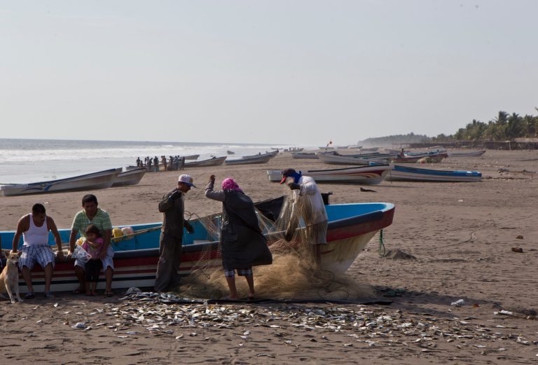 Fishermen untangle a fishnet in the hometown of sea survivor  Jose Salvador Alvarenga, Garita Palmera, El Salvador, Tuesday, Feb. 4, 2014. Alvarenga's survival after more than 13 months in an open boat has proven a double miracle for his family, who lost touch with him years ago and thought he was dead. Alvarenga says he left Mexico in December 2012 for a day of shark fishing and ended up on the remote Marshall Islands. (AP Photo/Esteban Felix)