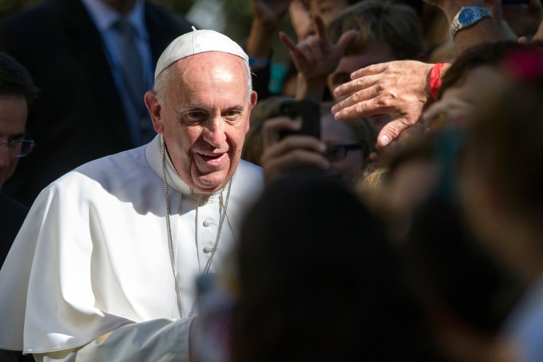 A man reaches out to touch Pope Francis as he prepares to depart the Apostolic Nunciature, the Vatican's diplomatic mission in the heart of Washington, en route to the Basilica of the National Shrine of the Immaculate Conception, Wednesday, Sept. 23, 2015. (AP Photo/Cliff Owen)