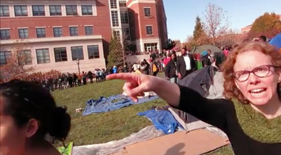 Professor who pushed, threatened journalist has been charged with assault