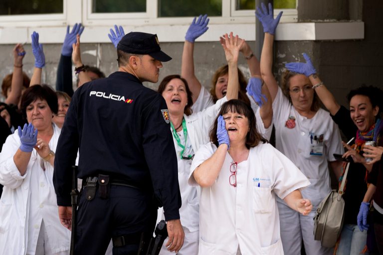 Medical practitioners shout against Spain's Prime Minister Mariano Rajoy during his visit to the Carlos III hospital in Madrid, Spain, Friday, Oct. 10, 2014. A Spanish hospital official says the nursing assistant infected with Ebola is 