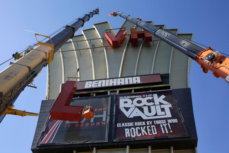 Construction workers lower part of the LVH sign Tuesday, July 1, 2014 in Las Vegas. Florida-based timeshare company Westgate Resorts announced it purchased the Las Vegas Hotel & Casino from Goldman Sachs and Gramercy Capital and would rename it Westgate Las Vegas Resort & Casino. Some of the nearly 3,000 rooms and suites will be converted to timeshare villas, while others will remain open to regular hotel guests. (AP Photo/John Locher)