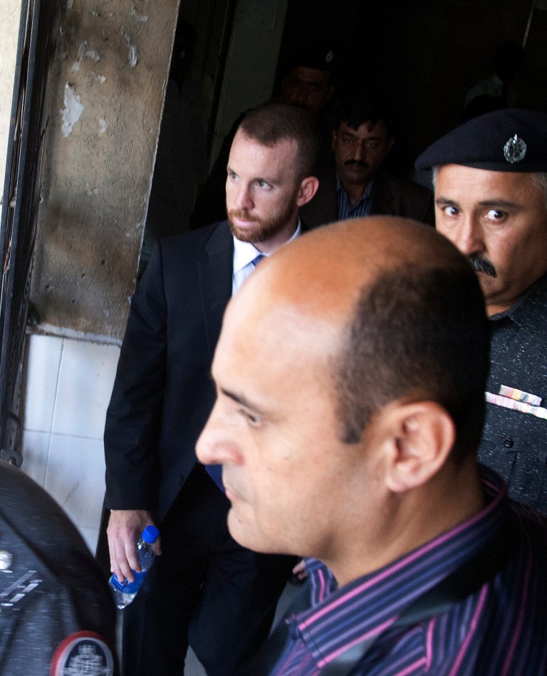 Joel Cox, an American working for the FBI, who was detained May 5 after officials found ammunition in his luggage at an airport, leaves a court in Karachi, Pakistan, Monday, May 19, 2014. Pakistani police officer Khalid Mahmood said the judge Monday dismissed the case after police produced a letter from the Ministry of Interior attesting that the agent was allowed to carry a weapon while in Pakistan and therefore any ammunition was legal. (AP Photo/Shakil Adil))