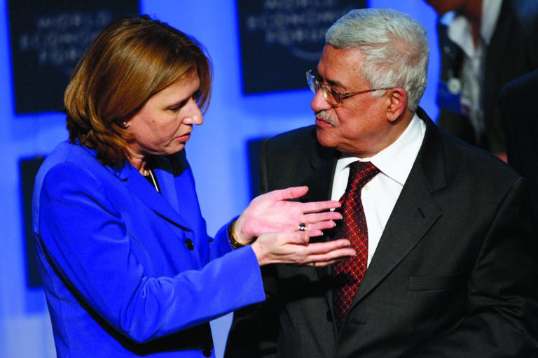 FILE - In this Jan. 25, 2007 file photo, Israeli Foreign Minister Tzipi Livni, left, and President of the Palestinian Authority Mahmoud Abbas talk after a plenary session on the Middle East during the World Economic Forum in Davos, Switzerland. The Palestinian president will invite Israeli politicians to the West Bank to try to make sure peacemaking is on the new government's agenda, a senior official said Thursday Jan. 24, 2013, as a top Israeli hard-liner proposed sidelining the polarizing issue.(AP Photo/Keystone/Alessandro della Valle, File)