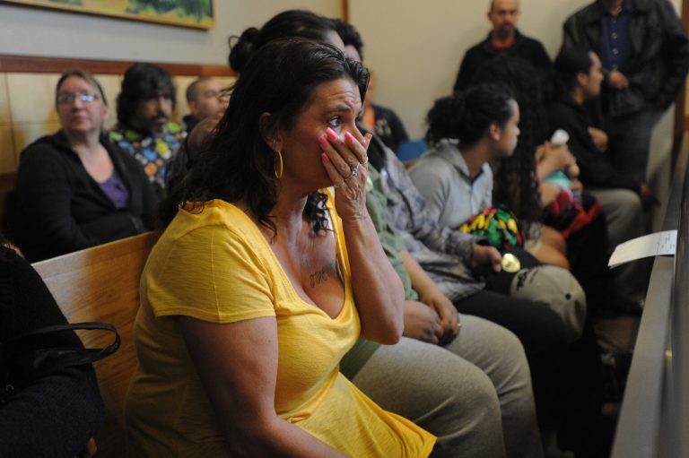   Michelle Virgilio reacts to seeing her 25-year-old daughter Gina Virgilio arrive in the Anchorage, Alaska jail court for her arraignment on Monday, June 11, 2012. Virgilio is accused of dousing her boyfriend Michael Gonzales, 24, with gasoline as he slept on the couch and setting him ablaze, killing him. She was arraigned on charges of first-degree murder, arson, criminal mischief, reckless endangerment and assault. Her bail was set at one million dollars. (AP Photo/Anchorage Daily News, Bill Roth)  