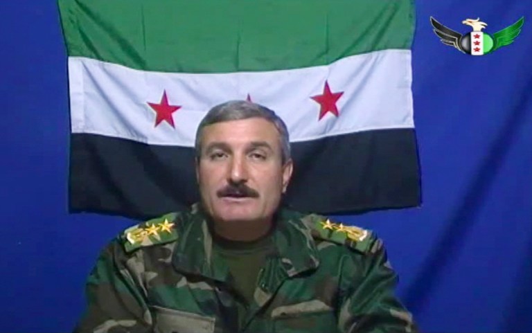 FILE - In this undated file photo, Syrian Commander Riad al-Asaad, who heads a group of Syrian army defectors appears on a video posted on the group's Facebook page. The Britain-based Syrian Observatory for Human Rights said Monday March 25, 2013 a bomb stuck to his car targeted Col. Riad al-Asaad during a visit to the town of Mayadeen in eastern Syria. The Observatory cited conflicting reports on al-Asaad's fate, with some saying he had been killed and others saying he lost a leg. There was no immediate claim of responsibility for the attack. (AP Photo/Free Syrian Army) THE ASSOCIATED PRESS HAS NO WAY OF INDEPENDENTLY VERIFYING THE CONTENT, LOCATION OR DATE OF THIS VIDEO IMAGE.
