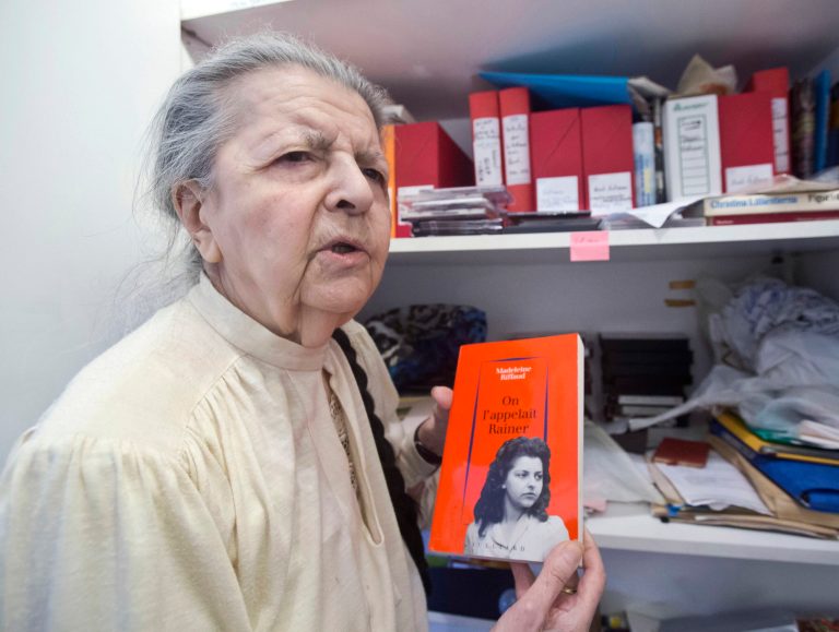 This Tuesday Aug. 19, 2014 photo shows French poet, journalist, and a member of the French Resistance Madeleine Riffaud answering a reporter during an interview with the Associated Press in Paris. She holds a book she wrote, with on the cover, a photo of her at the time of WWII. She had a code name, Rainer, and a gun she called Oscar. Just weeks before turning 20, she aimed her weapon at a Nazi officer and shot him dead on a Paris bridge. (AP Photo / Michel Euler)