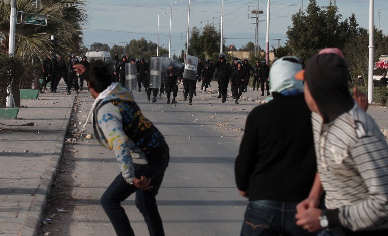   Tunisian protesters clash with riot police, in Siliana, Tunisia, Saturday, Dec. 1, 2012. The army moved into a southwestern Tunisian town, an official and witnesses said Friday, the fourth day of protests that have injured more than 300 people. President Moncef Marzouki said on television that the North African country's government has not 
