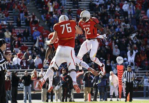 Maryland tight end Devonte Campbell, obstructed, offensive linesman R.J. Dill (76) and wide receiver Kevin Dorsey (12) celebrate Campbell's touchdown in the first half of an NCAA college football game against Virginia in College Park, Md., Saturday, Nov. 5, 2011. 
