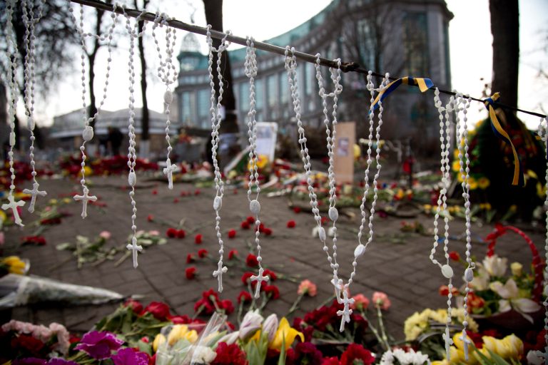 Rosary beads hang on a barricade in Kiev's Independence Square, the epicenter of the country's current unrest, Ukraine, Monday, Feb. 24, 2014. Ukraine's acting government issued a warrant Monday for the arrest of President Viktor Yanukovych, last reportedly seen in the pro-Russian Black Sea peninsula of Crimea, accusing him of mass crimes against protesters who stood up for months against his rule. (AP Photo/Darko Bandic)