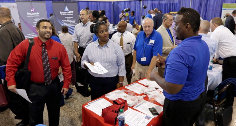 In this photo taken Wednesday, July 16, 2014, job seekers check out the opportunities at a Hiring Fair For Veterans in Fort Lauderdale, Fla. The Labor Department reports on the number of people who applied for unemployment benefits last week on Thursday, Aug. 7, 2014. (AP Photo/Alan Diaz)