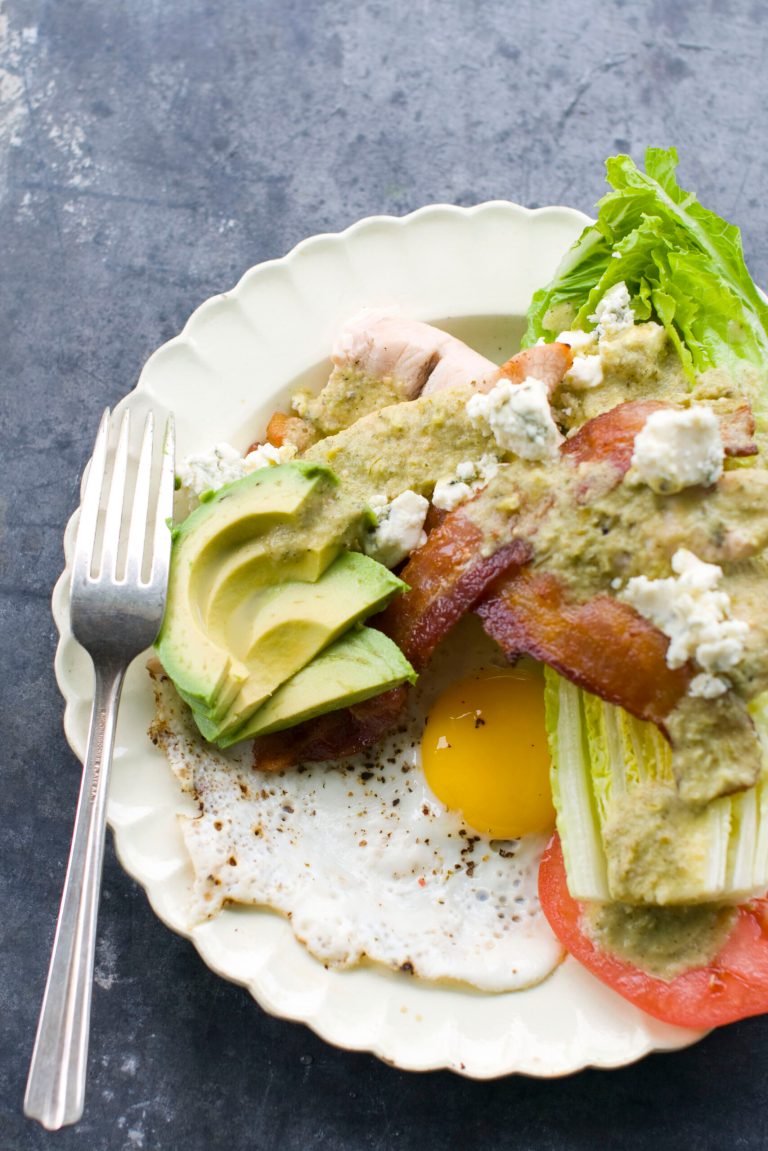   This image taken on May 30, 2012 in Concord, N.H. shows a grilled Cobb salad made with chicken, egg, avocado, tomato, bacon, blue cheese, and greens displayed on a plate. (AP Photo/Matthew Mead)  