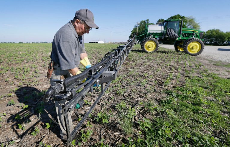 Ray Gaesser works on a sprayer on his farm, Wednesday, June 11, 2014, near Corning, Iowa. (AP Photo/Charlie Neibergall)