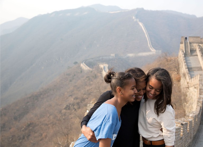 First Lady Michelle Obama hugs daughters Sasha, left, and Malia as they visit the Great Wall of China in Mutianyu, China, March 23, 2014. (Official White House Photo by Amanda Lucidon)