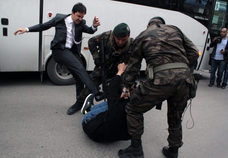 In this photo taken Wednesday, May 14, 2014  a person identified by Turkish media as Yusuf Yerkel, advisor to Turkish Prime Minister Recep Tayyip Erdogan, kicks a protester already held by special forces police members during Erdogan's visiting  Soma, Turkey. Erdogan was visiting the western Turkish mining town of Soma after Turkey's worst mining accident . AP Photo/Depo Photos) TURKEY OUT  ONLINE OUT