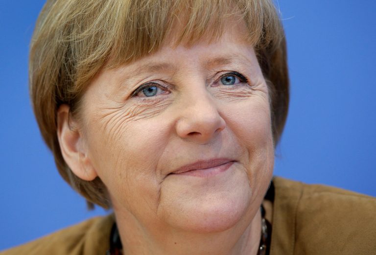 German Chancellor Angela Merkel smiles during her annual summer press conference in Berlin, Germany, Friday, July 18, 2014. (AP Photo/Michael Sohn)