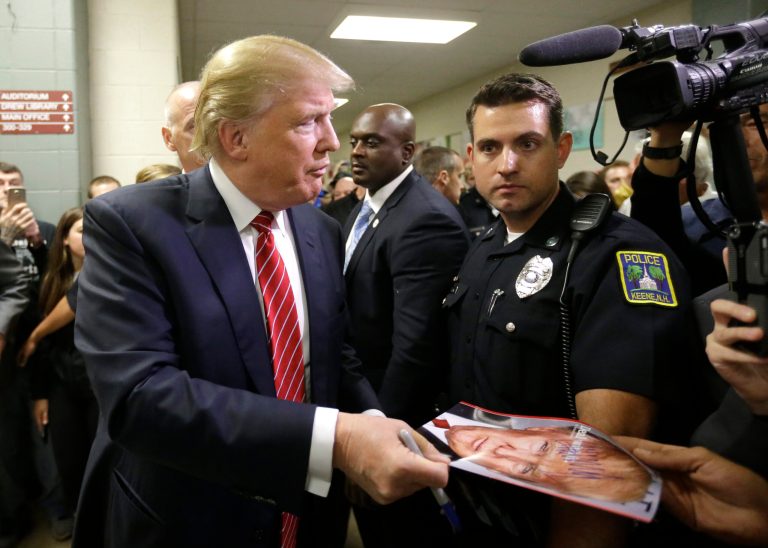 Republican presidential candidate, businessman Donald Trump signs autographs as he arrives at a campaign stop, Wednesday, Sept. 30, 2015, in Keene, N.H. (AP Photo/Steven Senne)