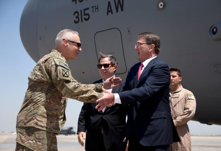 U.S. Defense Secretary Ash Carter is greeted by U.S. Ambassador to Iraq Stu Jones, center and Army Lt. Gen. James Terry, left, as he arrives at the Baghdad International Airport in Iraq, Thursday, July 23, 2015. Carter is on a week long tour of the Middle East focused on reassuring allies about Iran and assessing progress in the coalition air campaign against the Islamic State in Syria and Iraq. (AP Photo/Carolyn Kaster, Pool)