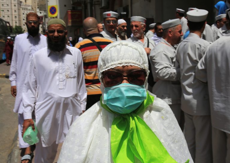 A Muslim pilgrim wears a surgical mask to help prevent infection from a respiratory virus known as the Middle East Respiratory Syndrome (MERS) in the holy city of Mecca, Saudi Arabia, Tuesday May, 13, 2014. Saudi health authorities reported another five deaths Tuesday from MERS that has sickened hundreds and killed over 150 people. (AP Photo/Hasan Jamali)