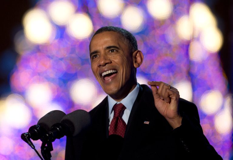President Barack Obama, speaks as the National Christmas Tree glows behind him during the National Christmas Tree Lighting ceremony at the Ellipse near the White House in Washington, Friday, Dec. 6, 2013. (AP Photo/Carolyn Kaster)