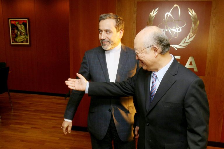 Director General of the International Atomic Energy Agency, Yukiya Amano, right, welcomes Iranian deputy Foreign Minister Abbas Araghchi to the IAEA headquarters in Vienna on Nov. 24. (AP Photo)
