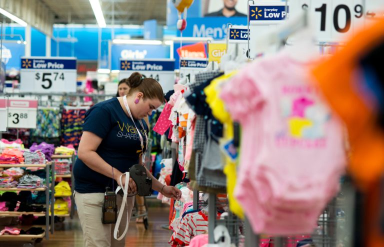 In this June 5, 2014 photo, Mary Bullen, merchandise supervisor of the infant and girls section, makes price changes to clothing at the Wal-Mart Supercenter in Rogers, Ark. Wal-Mart Stores Inc. reports quarterly financial results after the market closes on Thursday, Aug. 14, 2014. (AP Photo/Sarah Bentham)