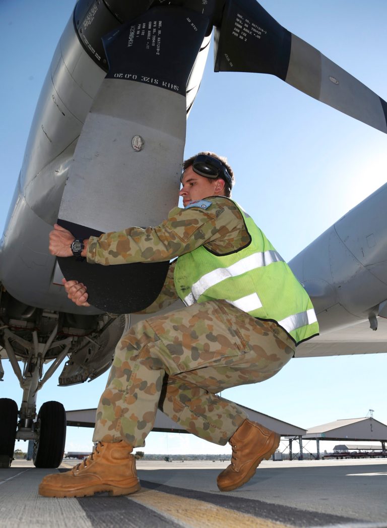 In this Tuesday, April 8, 2014 photo, Leading Aircraftman Andrew Smith works on a propeller of a Royal Australian Air Force P-3 Orion at RAAF Base Pearce after it arrived back from the ongoing search operations for the missing Malaysia Airlines Flight 370 in Perth, Australia. The ground crews typically work on the tarmac through the night so the planes are ready to fly again by daylight, as the international effort to find some trace of the missing jetliner continues. (AP Photo/Rob Griffith)