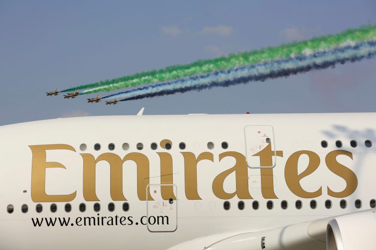 The Emirati Al-Fursan aerobatic team fly past an Emirates A380 during the Dubai Airshow on Nov. 18 in Dubai, United Arab Emirates. (Christopher Furlong/Getty Images)