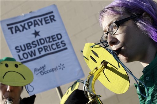 A members of the Rude Mechanical Orchestra play as they join in a protest against Wal-Mart on Black Friday, Nov 23, 2012, in Secaucus, N.J.  Wal-Mart employees and union supporters are taking part in today's nationwide demonstration for better pay and benefits. A union-backed group called OUR Walmart, which includes former and current workers, was staging the demonstrations and walkouts at hundreds of stores on Black Friday, the day when retailers traditionally turn a profit for the year. (AP Photo/Mel Evans)