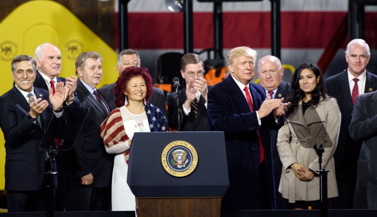 President Trump (pictured center-right) stands with many of the Pennsylvania delegation during an official visit at H&K Equipment, a rental and sales company for specialized material handling solutions in Coraopolis, Pennsylvania, on Jan. 18, 2018. Trump visited the facility to talk about the Republican tax reform policy that was passed in late December. (Photo by Justin Merriman for the Washington Examiner)