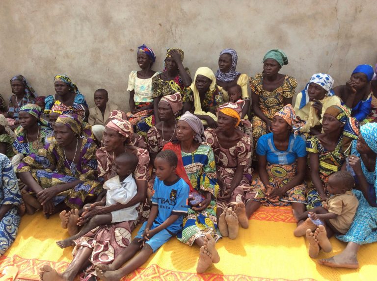 In this Jan. 31, 2014, photo, women and children who survived attacks by Boko Haram sit outside a compound at St. Paul's Roman Catholic Church, in Wada Chakawa, Yola, Nigeria. (AP Photo/ Ibrahim Abdulaziz)